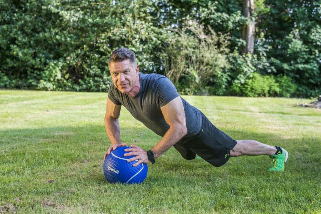 Functional training: Man doet push up op een medicine ball